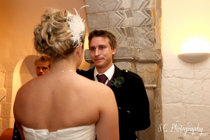 A teary-eyed groom reads his own written vows to his bride. Edinburgh, Scotland